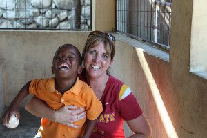 Meeting a new friend, full of smiles, on my trip to Haiti.