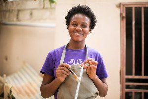 Makensia works as a jewelry maker with our partner, Papillon, in Haiti.