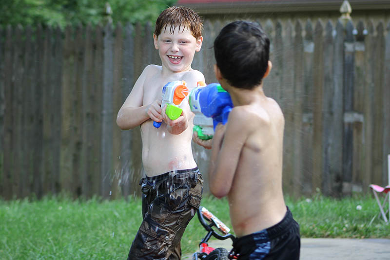 boys playing with super soakers