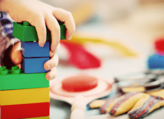 kid building with legos
