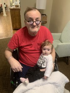 Granddaughter sitting on Grandpa's lap