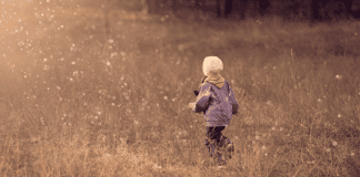 kid walking in field