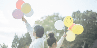 holding balloons