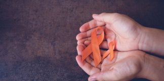 pic of hands holding orange ribbons for MS awareness