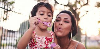 pic of mom and daughter blowing bubbles