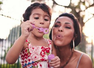 pic of mom and daughter blowing bubbles