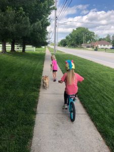 kids riding bike and walking dog