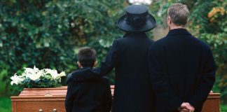 pic of family standing by a casket