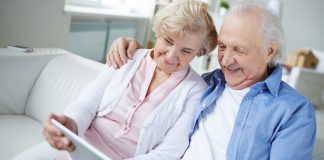 pic of an older couple looking at a tablet together