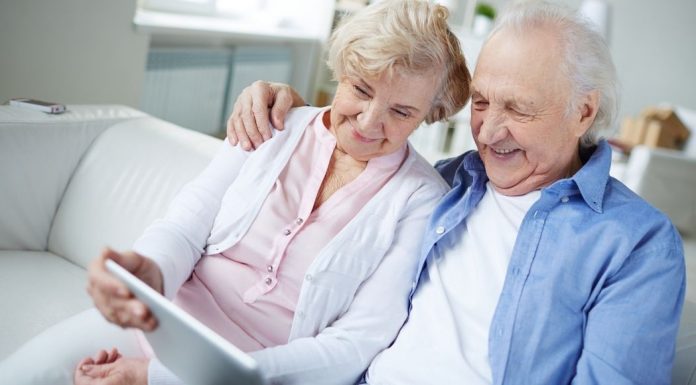 pic of an older couple looking at a tablet together