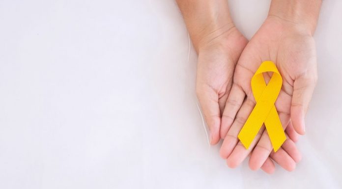 pic of woman's hands holding suicide prevention awareness ribbon
