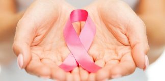 pic of woman's hands holding a pink ribbon