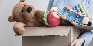 pic of woman holding box of toys