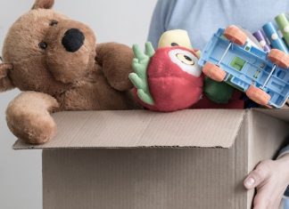 pic of woman holding box of toys