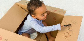 Toddler in Cardboard Box