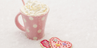 hot chocolate in pink mug with heart cookies