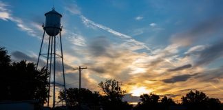 pic of a farm's water tower at sun rise