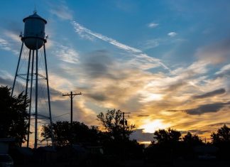pic of a farm's water tower at sun rise
