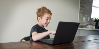 boy doing virtual learning at the kitchen table