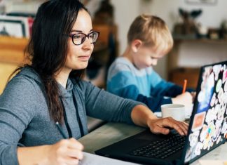 mom working from home on computer with child nearby