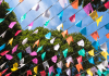 June Bucket List for Kansas City Families banner flags against sky and trees