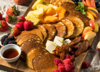 charcuterie board with pancakes, fruit