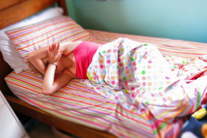teen girl sleeping in bed