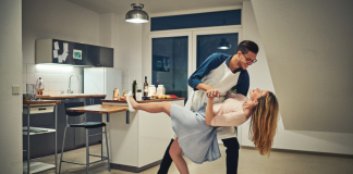 man and woman dancing at home