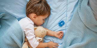 toddler sleeping with stuffed animal