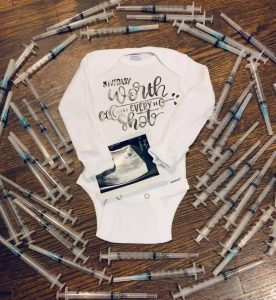 onesie with ultrasound and syringes
