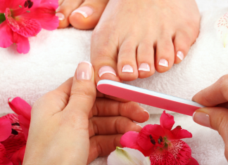 hand filing nails on foot during pedicure