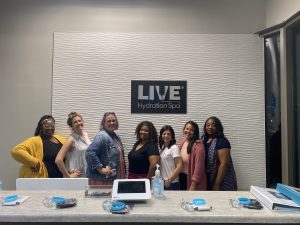 group of women in front of Live Hydration Spa sign