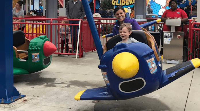 mom and kid riding plane ride at Worlds of Fun