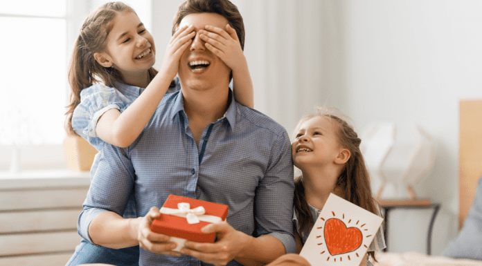 dad with girls giving gifts
