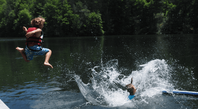 kids jumping into lake