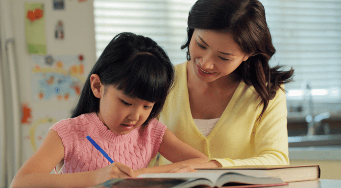 mom with girl writing in notebook