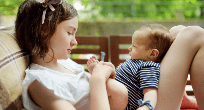 girl babysitting baby