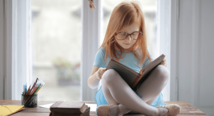 girl reading chapter book