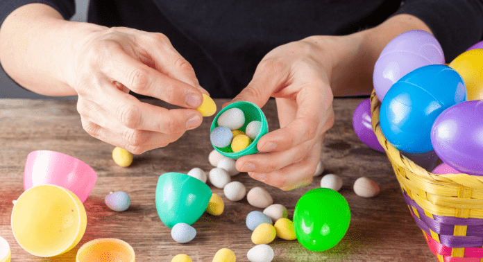mom filling Easter eggs with candy