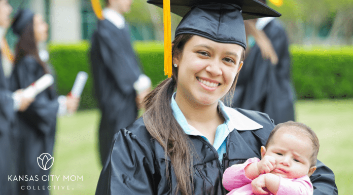 graduate holding baby