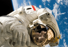 Astronaut floating in space with Earth behind