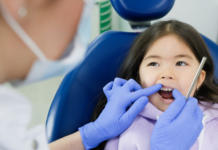 child getting teeth examined by dentist
